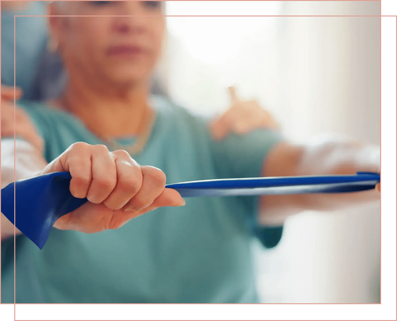 An elderly person exercising with a resistance band.
