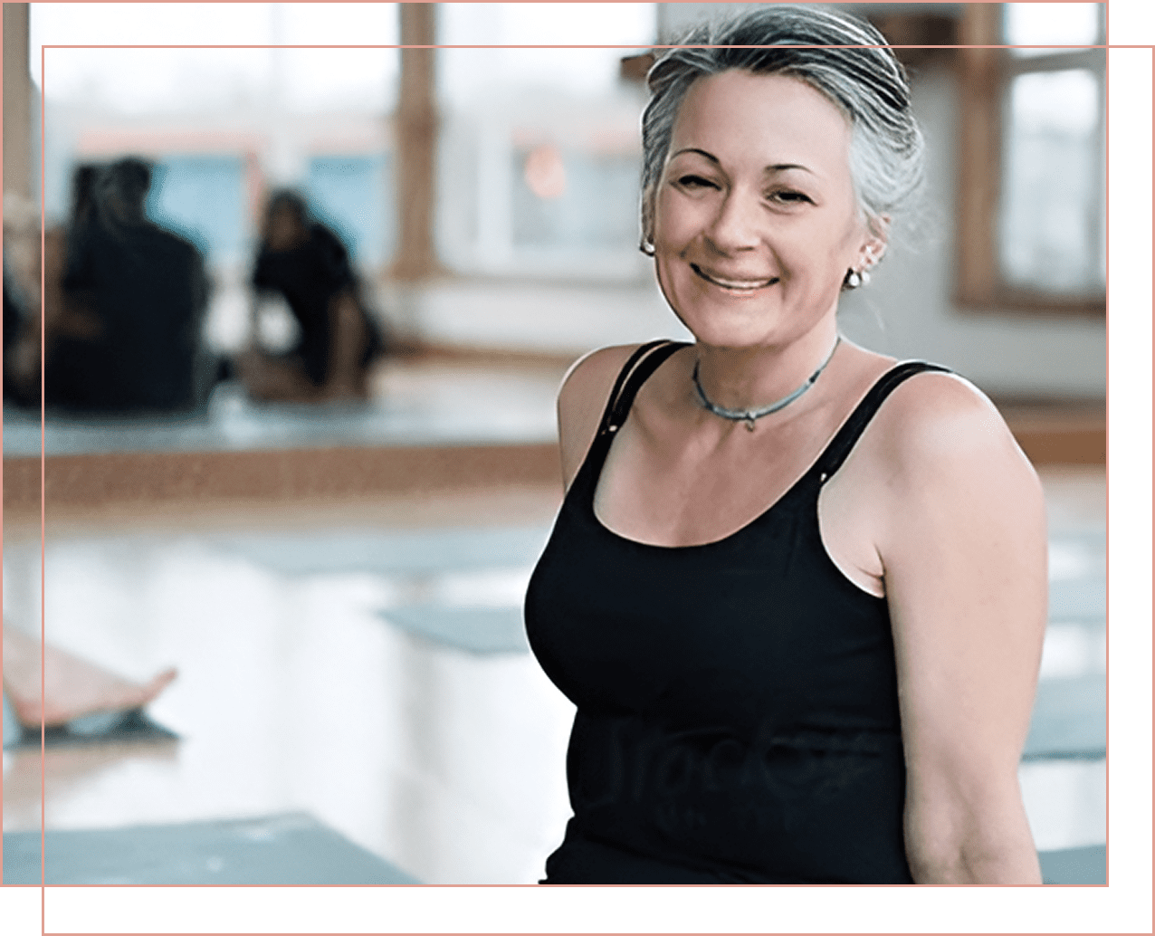 Smiling woman in black workout attire during exercise.