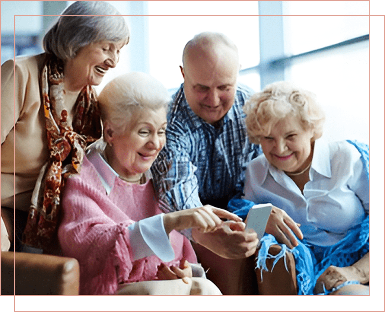 Seniors happily exploring a smartphone together.