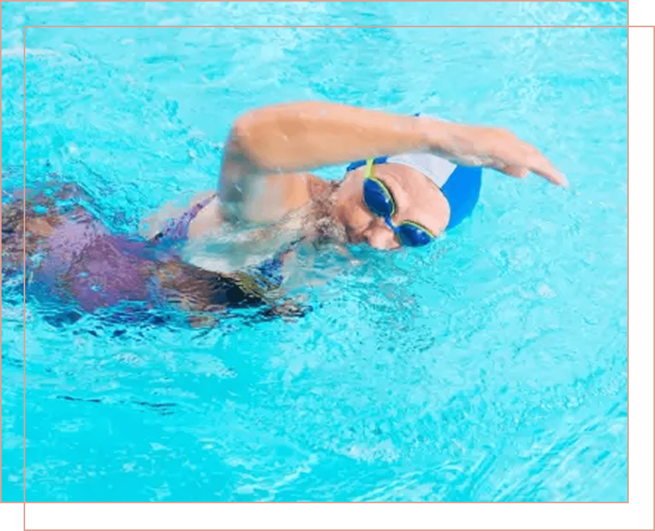 Swimmer in blue cap and goggles doing freestyle stroke in pool.